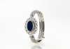 Oval shaped blue sapphire kada surrounded by round diamonds in 18carat white gold